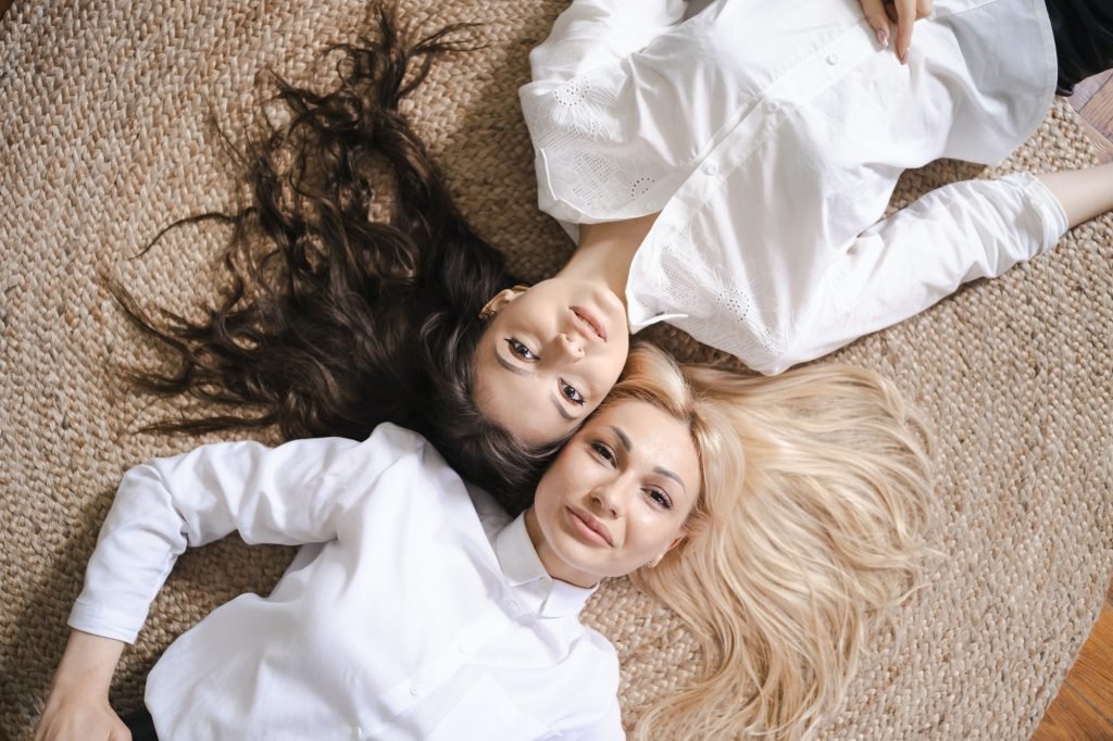 Mom and daughter lying on floor