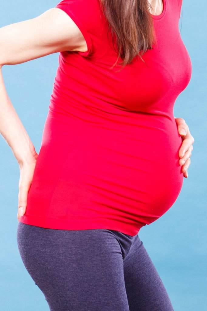 Pregnant woman with stomach or back pain, health care and aches in pregnancy, risk of miscarriage